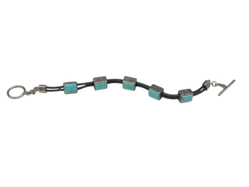 VINTAGE NAVAJO ARTIST SIGNED STERLING SILVER TURQUOISE LINK BRACELET WITH LEATHER STANDS: FEATURING FIVE RECTANGULAR TURQUOISE LINKS AND TOGGLE CLASP 7 1/2", 1/2" LINKS, 22.17 GRAMS 