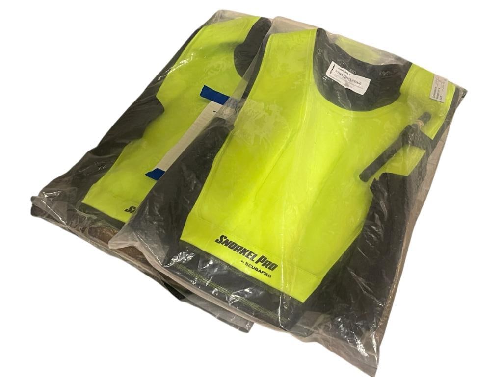 TWO NEW IN PACKAGE SNORKEL PRO CRUISER SKIN SNORKELING VESTS BY SCUBAPRO: FEATURE FLOURESCENT DESIGN ONE LARGE AND ONE MEDIUM 