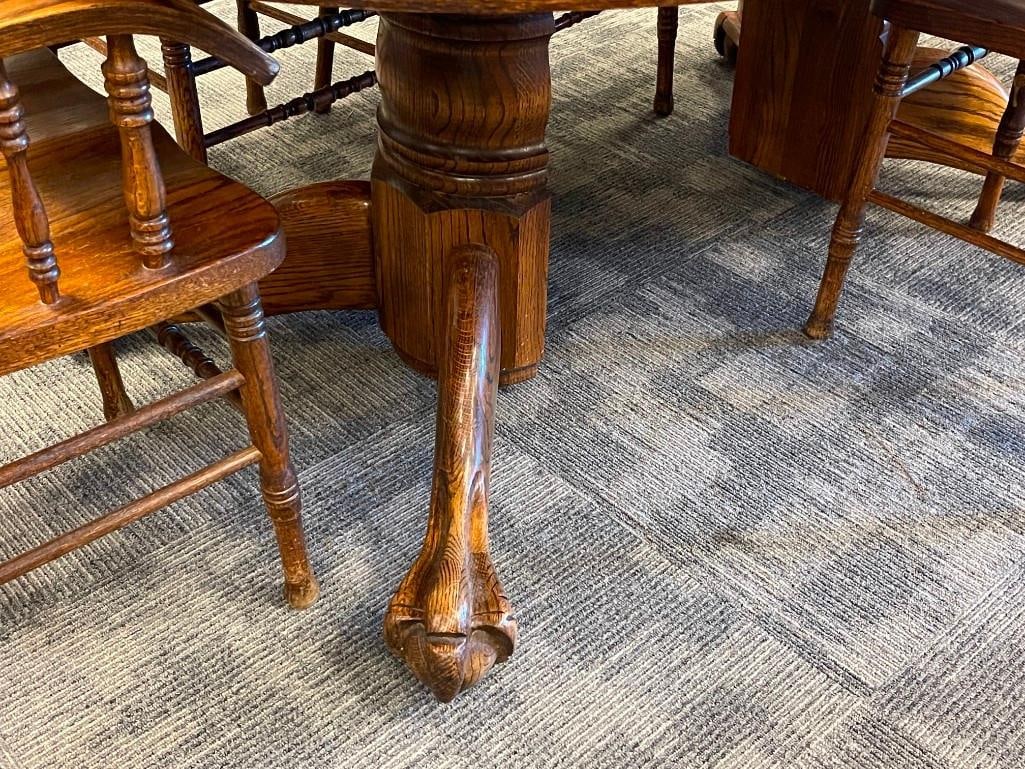 VINTAGE DARK STAINED OAK PEDESTAL CLAW FOOT DINING TABLE WITH SIX PRESSED BACK CHAIRS WITH LEAVES - 6