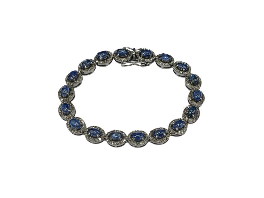 CHARMING 14K WHITE GOLD PLATED STERLING SILVER OVAL CABOCHON KYANITE AND DIAMOND BRACELET: FEATURING 19 BLUE KYANITES SET IN DIAMOND HALO LINKS CONSISTING OF 360 ROUND CUT DIAMONDS, INCLUDES CRG APPRAISAL, APPRAISED VALUE OF $7,500.00, SEE APPRAISAL 7 1/2" X 3/8", 14.50CTTW KYANITES, 2.50CT