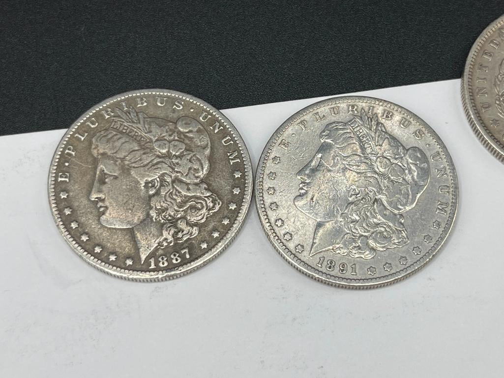 FIVE U.S. MORGAN SILVER DOLLARS FEATURING VARIOUS DATES AND MINT MARKS - 7