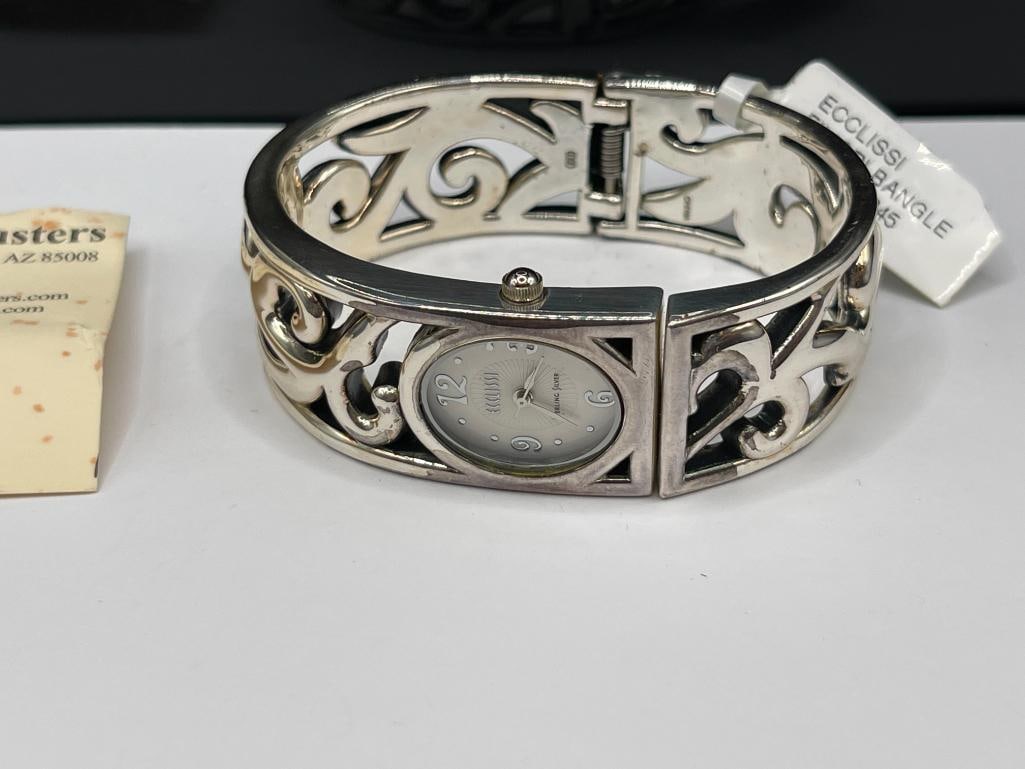 ECCLISSI STERLING SILVER WATCH BANGLE BRACELET FEATURING FILIGREE LIKE DESIGN: WATCH NEEDS BATTERY, INCLUDES CARD FROM INVENTORY ADJUSTERS, HINGED DESIGN 2 1/2" WRIST WIDTH, 3/4" THICK, 68.86 GRAMS 