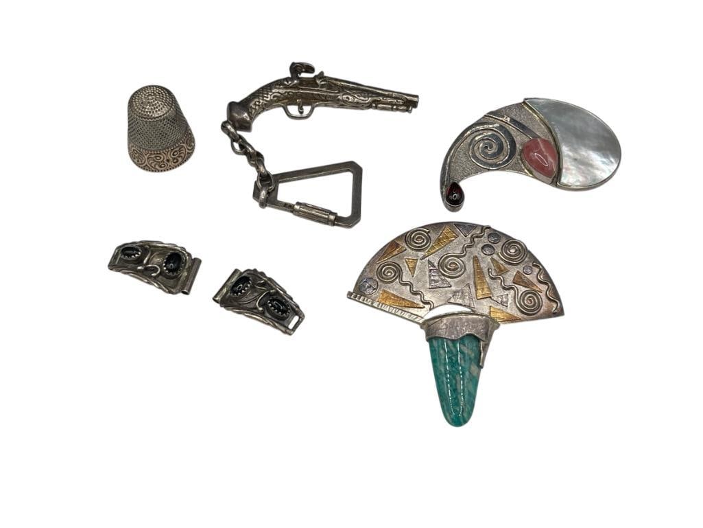 SIX PIECES OF STERLING SILVER JEWELRY INCLUDES BROOCHES AND A THIMBLE: INCLUDES A FIGURAL FLINTLOCK PISTOL DESIGN, PAIR OF WATCH TIPS SIGNED "RB," THIMBLE WITH GOLD ACCENT, SAJEN SIGNED BROOCH, AND MORE LARGEST IS 2 1/4", 68.82 GRAMS TOTAL 