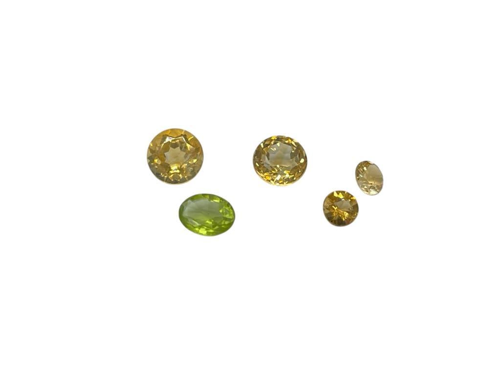 FOUR ROUND CUT CITRINE AND ONE OVAL CUT PERIDOT: 5.55CTTW 