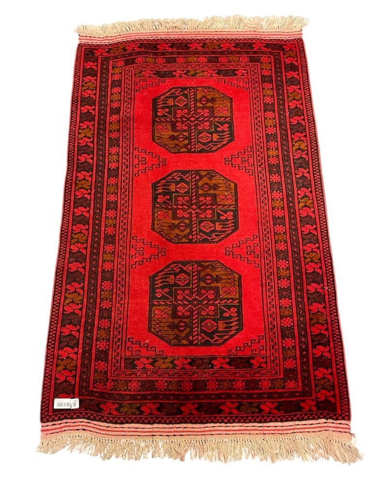 SEMI-ANTIQUE TURKMEN SULAYMAN AFGHAN GEOMETRIC DESIGN AREA RUG: VIBRANT RED AND BLACK AREA RUG WITH FRINGE, FRINGE DOES SHOW WEAR DYE HAS BLED, ORIGINAL SALES TAG ON THE BOTTOM, IN GOOD CONDITION WITH NO HEAVY SIGNS OF USE 54" X 33"