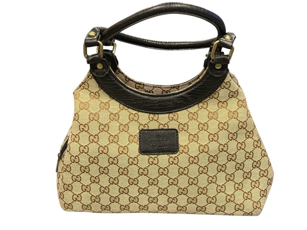GUCCI GG MNOGRAM SUKEY HOBO BAG BROWN MONOGRAM ICONIC DESIGN: LEATHER HANDLES AND TRIM, LITTLE TO NO SIGNS OF WEAR, BELIEVED TO BE AUTHENTIC 12" X 4" X 9 1/2"