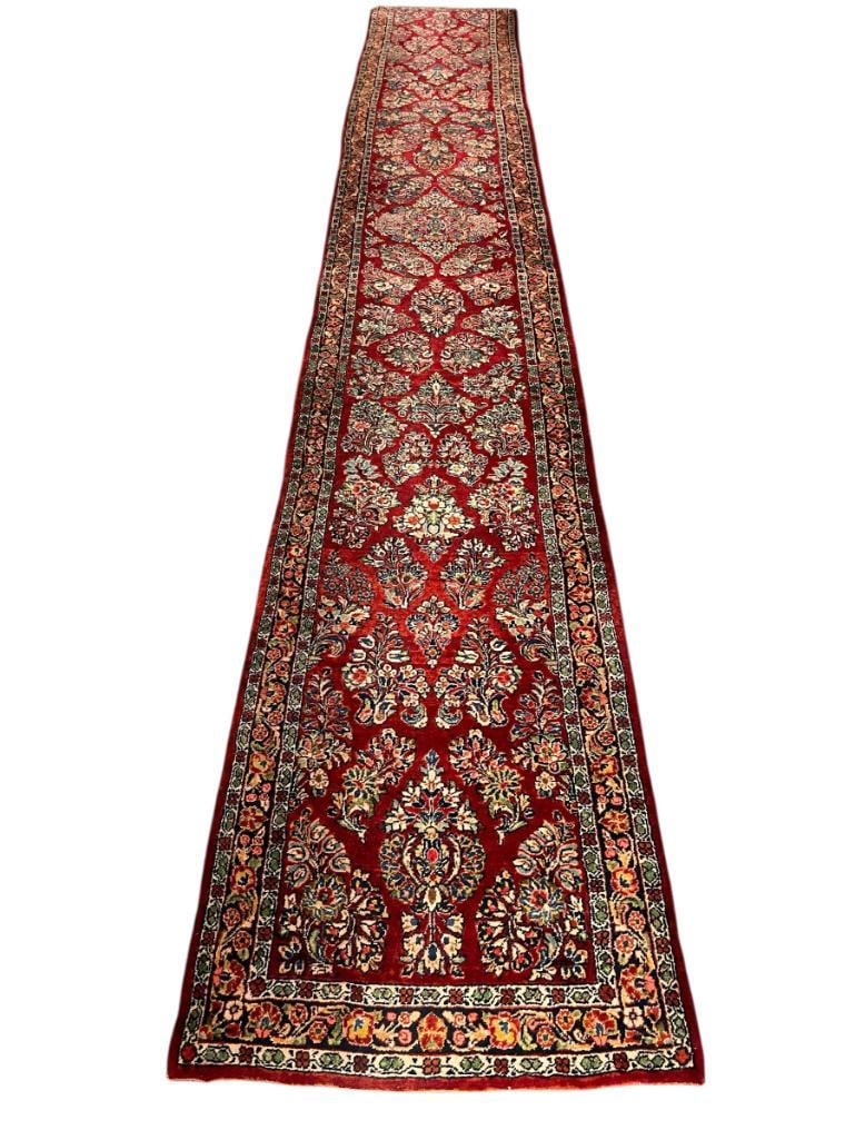 SEMI-ANTIQUE HAND WOVEN WOOL PILE PERSIAN SAROUK LONG HALLWAY COLOR: VIBRANT RED AND FLORAL DESIGN HALLWAY RUNNER WITH GREEN, BLUE, AND BEIGE TONES, IN GOOD CONDITION, LIGHT SIGNS OF WEAR 192" X 30"