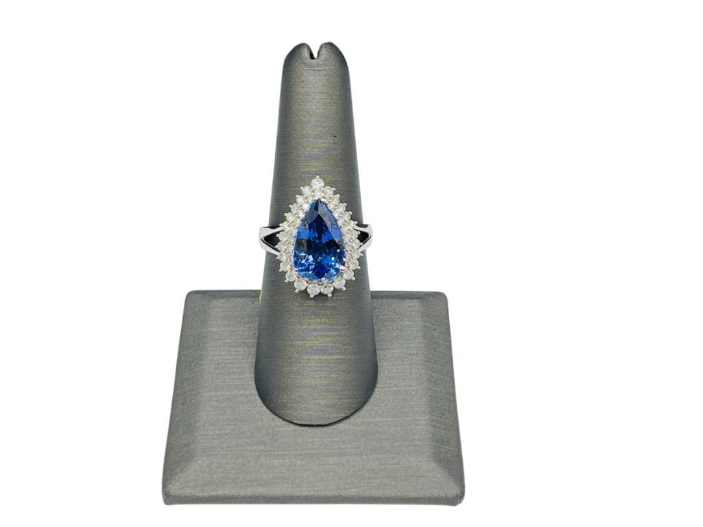14K WHITE GOLD PEAR CUT TANZANITE AND ROUND BRILLIANT CUT DIAMOND RING BY ORIANNE: FEATURING A PEAR MIXED CUT NATURAL TANZANITE ACCENTED BY 50 PRONG SET ROUND BRILLIANT CUT DIAMONDS, AIG APPRAISED VALUE OF $16,125.00, SEE APPRAISAL, HALLMARKED BY DESIGNER SIZE 7 1/2, 5.30CT TANZANIT