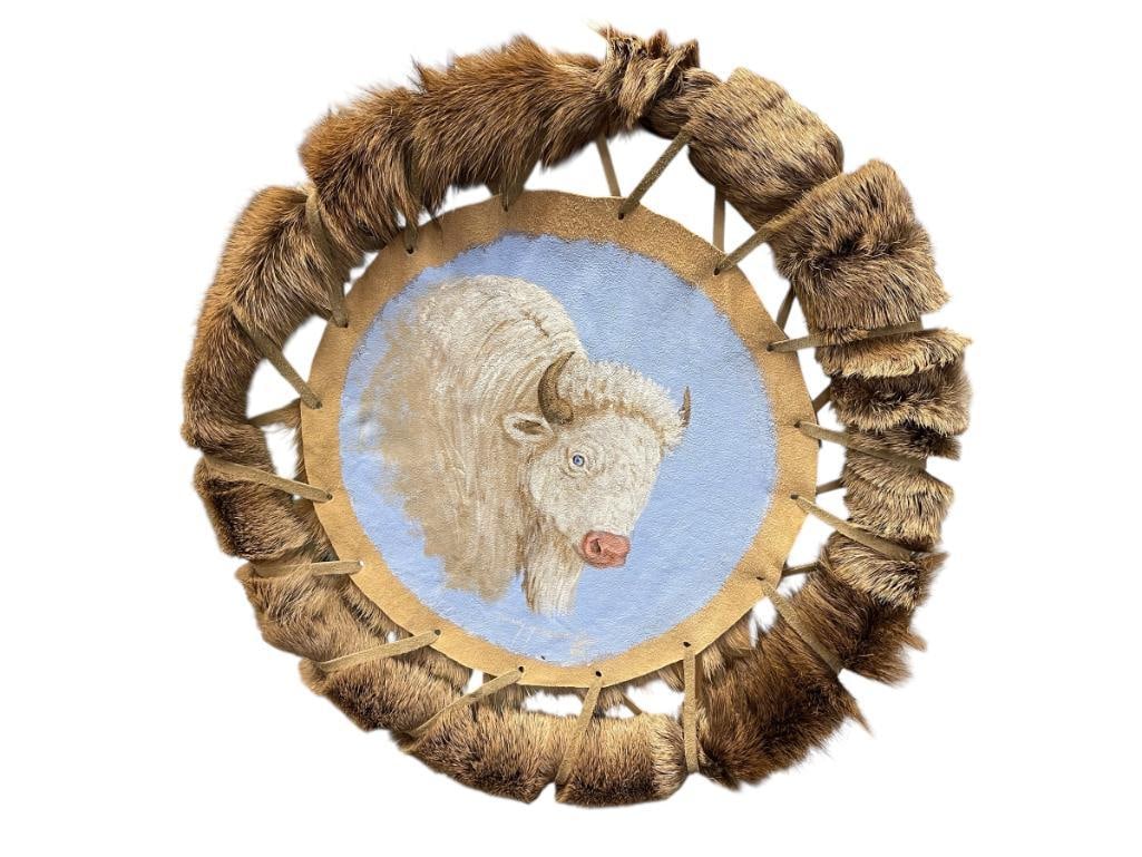 ORIGINAL OIL PAINTING ON DEER HIDE BY NAVAJO ARTIST JIMMY YELLOWHAIR OF WHITE ALBINO BUFFALO: JIMMY YELLOWHAIR OF HOUCK, ARIZONA, THIS PIECE IS SAID TO BE ORIGINALLY PURCHASED FROM ARTIST IN 2022, FEATURES DEER FUR WRAPPED DREAMCATCHER DESIGN, GREAT CONDITION, SIGNED BY ARTIST AT BOTTOM 
