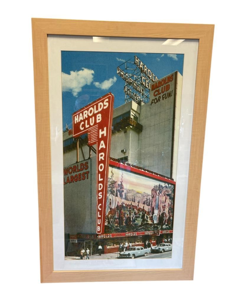 COLOR POSTER OF HISTORICAL MOMENT FEATURING THE FAMOUS HAROLDS CLUB CASINO IN RENO, NV: FOUNDED IN 1935 BY HAROLD SMITH, SCENE DEPICTS HAROLDS CLUB CASINO BUILDING WITH BUSY STREET FILLED WITH PEOPLE AND AUTOMOBILES, FRAMED 25" X 39 1/2" FRAME 