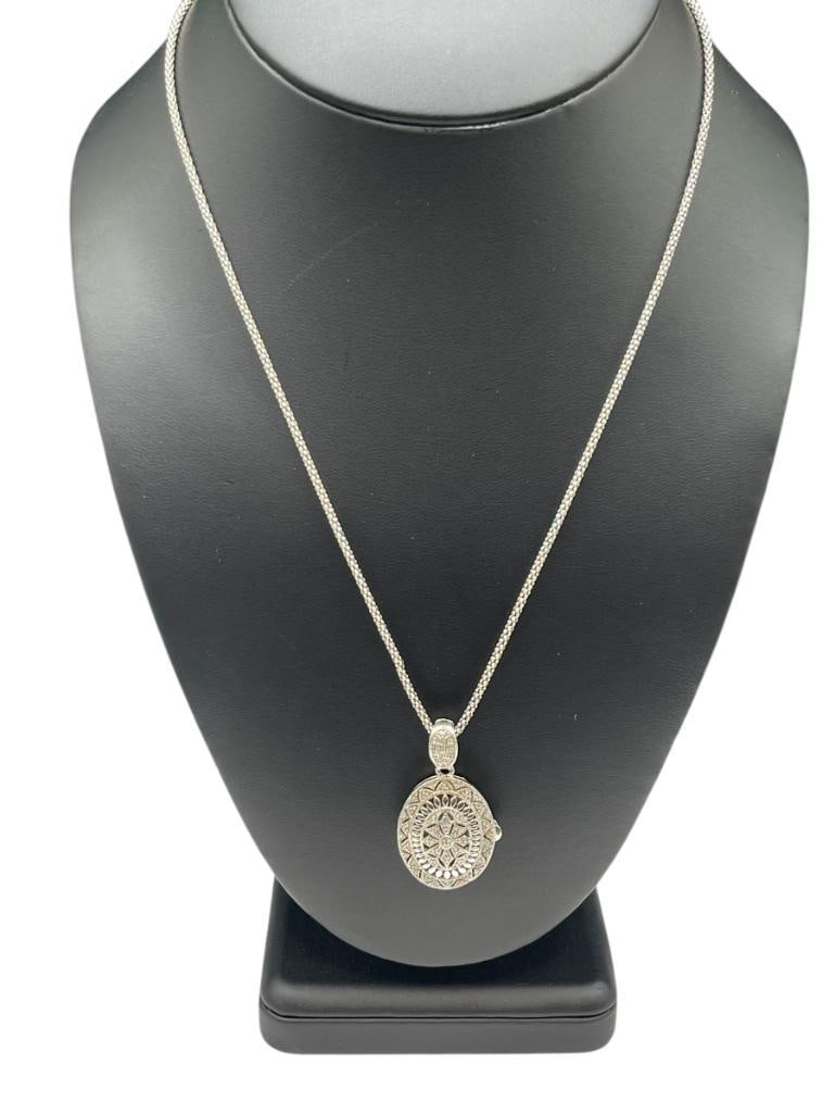 DESIGNER SIGNED RPG STERLING SILVER DIAMOND LOCKET AND STERLING SILVER NECKLACE: NECKLACE IS ITALIAN MADE, LOCKET FEATURES PIERCED DESIGN 19" NECKLACE, 1 1/2" LOCKET, 11.31 GRAMS TOTAL, DIAMONDS ARE LESS THAN 1MM EACH 
