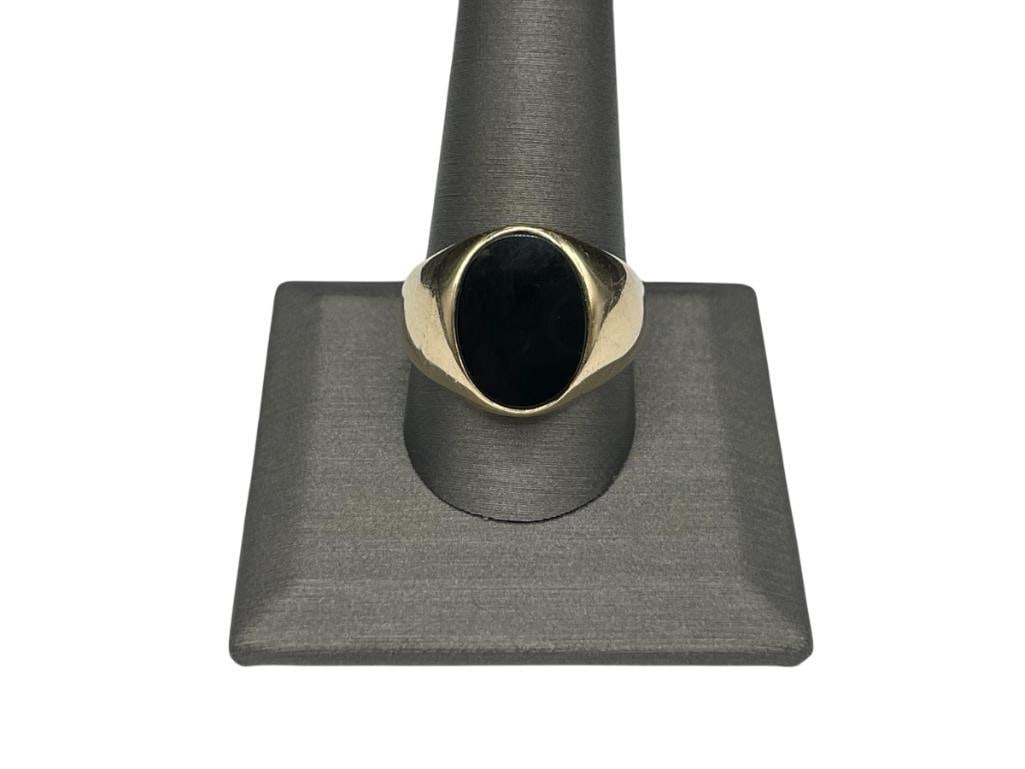 10K YELLOW GOLD BLACK ONYX GENTLEMEN'S RING: FEATURING FLUSH SETTING WITH OVAL ONYX SIZE 11 1/2, 11/16" FRONT, 9.99 GRAMS 