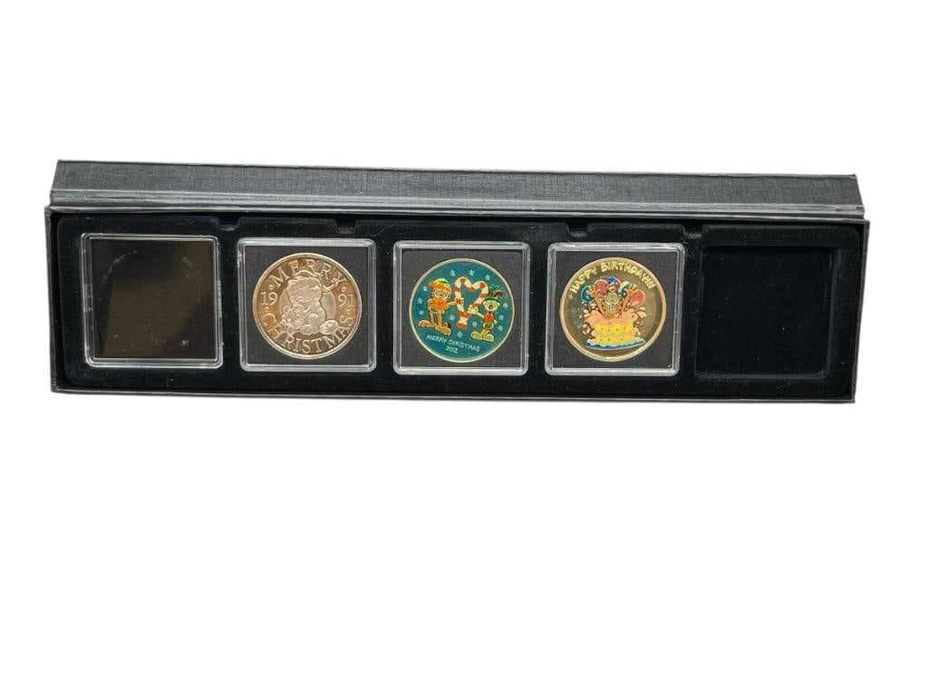 THREE CHRISTMAS / BIRTHDAY THEMED GARFIELD CARTOON .999 FINE SILVER ROUNDS INCLUDING TWO COLORIZED: IN CASE, INCLUDES 1991 AND 1992 CHRISTMAS THEMED COINS AND HAPPY BIRTHDAY COIN 1 TROY OUNCE EACH 