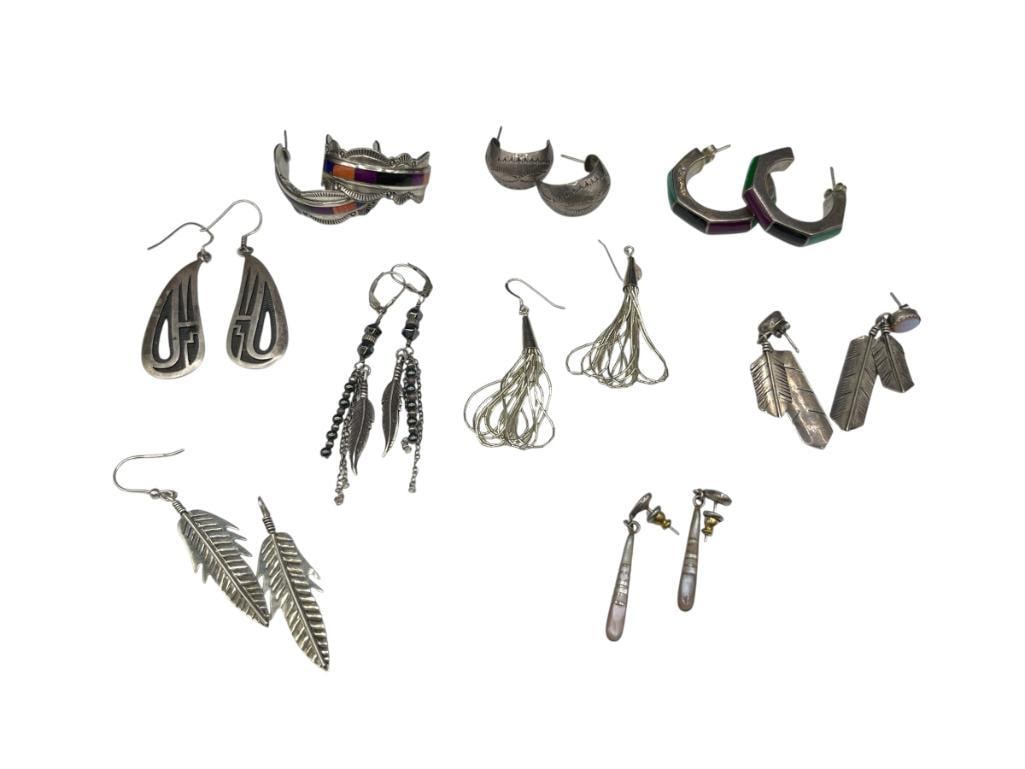 NINE PAIRS OF VINTAGE STERLING SILVER DANGLE AND HOOP EARRINGS INCLUDING NAVAJO AND MEXICO DESIGNS: SOME ARE SIGNED BY ARTIST, FIGURAL DESIGNS, LIQUID SILVER, INLAID STONE 3/4 HOOPS, AND MORE 76.42 GRAMS