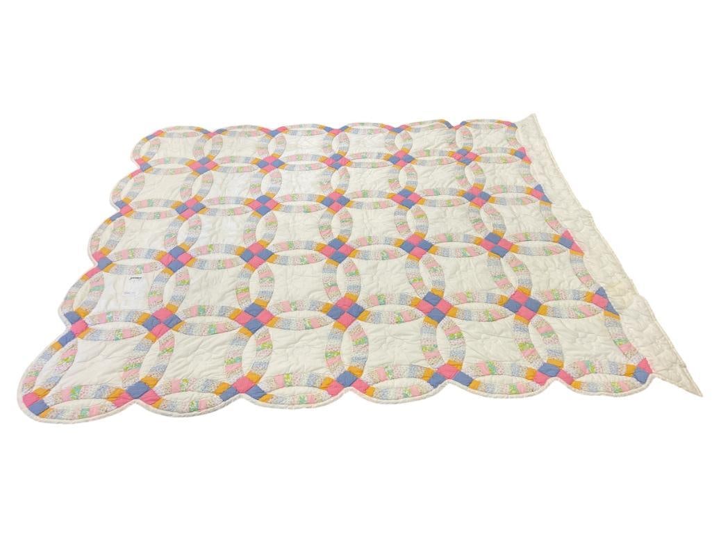 HAND CRAFTED DOUBLE WEDDING RING PATCHWORK QUILT: OVERALL IN GOOD CONDITION, ONE OF THE EDGES HAS STAIN 68" X 90"