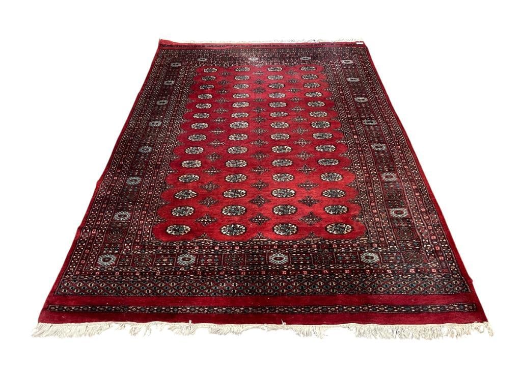 TURKOMAN BUKARA / BOKARA LOW WOOL PILE MEDALLION AREA RUG HAND KNOTTED: RED, BLACK, BLUE, BROWN AREA RUG WITH MEDALLION DESIGN AND FRINGE, SHOWS LIGHT WEAR SPOTS, BUT RUG MAINTAINS GOOD SHEEN AND COLOR, ORIGINAL PRICE OF $1,927 STATED BY THE ESTATE 75" X 109" 