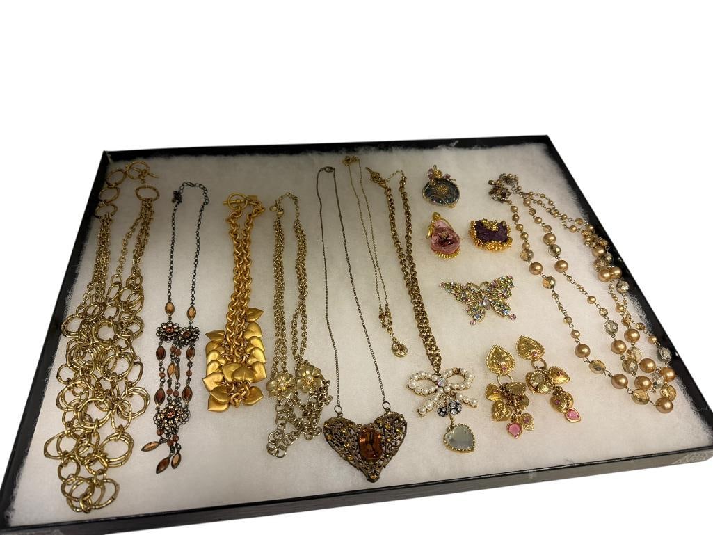 ASSORTED GOLD TONE LADIES COSTUME JEWELRY FEATURING PENDANT NECKLACES, BROOCHES, PENDANTS: INCLUDES FAUX PEARL DESIGNS, ANNE KLEIN, HEART DANGLE NECKLACE, RHINESTONE BUTTERFLY BROOCH, AND VIBRANT DESIGNS