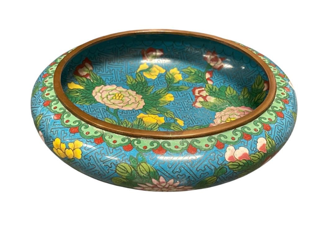GREAT MING DYNASTY CHINESE CLOISONNE ENAMELED BOWL ON COPPER WITH PEONIES AND LOTUS FLOWERS: ROUND CLOISONNE BOWL WITH LOTUS AND PEONIES WITH BLUE BACKGROUND, MARKED ON THE BOTTOM WITH CHARACTERS ON THE BOTTOM, IN GOOD CONDITION WITH NO HEAVY WEAR ON DENTS ALONG THE BODY 9 1/2" ROUND, 3"