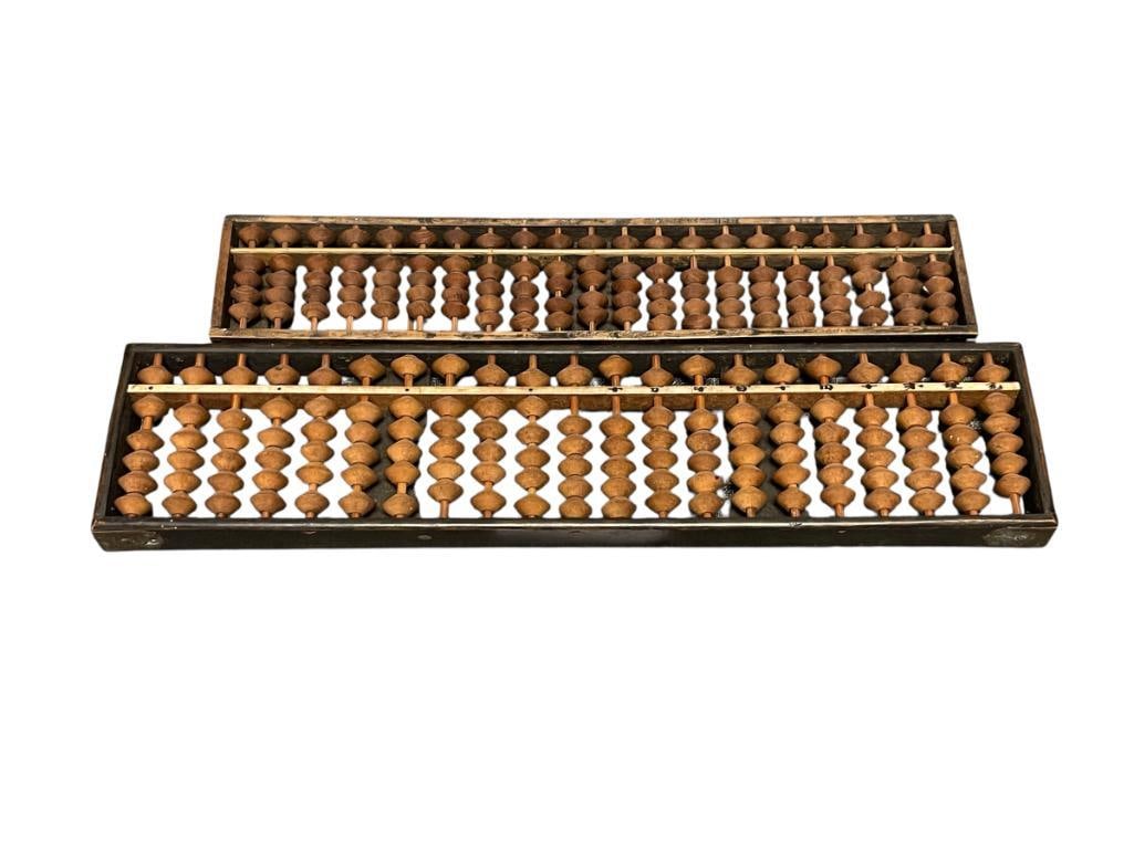 TWO EARLY 1900'S JAPANESE SOROBAN ABACUS MADE FROM WOOD WITH BRASS HARDWARE 126 AND 105 BEADS: BOTH FEATURE 21 COLUMNS WITH BICONICAL SHAPED BEADS WITH BAMBOO RODS, LARGE ABACUS IS MARKED IN JAPANESE CHARACTERS, BOTH ARE CONSTRUCTED FROM WOOD POSSIBLY RATTAN WITH BRASS CORNERS 12" AND 13 5/8"