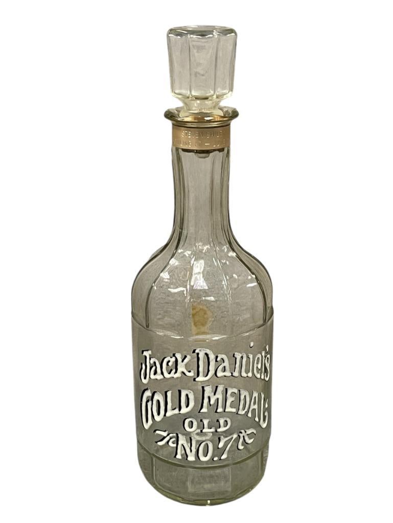 VINTAGE JACK DANIELS OLD NO. 7 COLLECTIBLE GLASS BOTTLE ST. LOUIS WORLD'S FAIR COMMEMORATIVE BOTTLE: WHITE AND BLACK ENAMELED LETTERING, WITH ORIGINAL STOPPER, FEATURES TAG PRESENTED TO AN INDIVIDUAL IN 1973, NO CRACKS OR CHIPS 15 1/4" H 