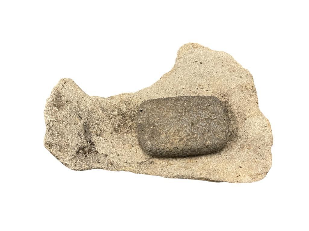 NATIVE AMERICAN ARTIFACT ROCK METATE AND MANO MORTAR AND PESTLE: PRIMITIVE ARTIFACT USED TO GRIND GRAINS, METATE SHOWS HEAVY SIGNS OF USE, MNO SHOWS WEAR IT HAS BEEN WORN DOWN TO A RECTANGULAR SHAPE 13" X 10" METATE, 5" X 3 1/2" MANO 