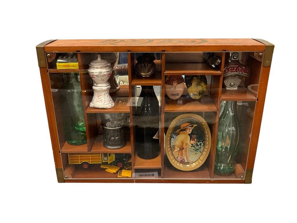 COCA-COLA CENTENNIAL CELEBRATION SHADOW BOX WITH MINIATURE COLLECTIBLES: FEATURES MINIATURES SUCH AS 1932 DELIVERY TRUCK, FOUNTAIN GLASS WITH PEWTER HOLDER, 1910 AMBER BOTTLE, CHANGE TRAY, STAR-X BOTTLE OPENER, AND MANY OTHER COLLECTIBLES IN A WOODEN CRATE DISPLAY WITH