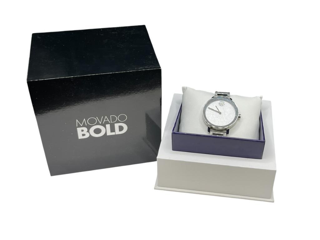 MOVADO BOLD LUXURY SWISS MADE LADIES WRISTWATCH FEATURING PAVE CRYSTAL SUN AT HIGH NOON: UNCLEAR BUT PAVE SUN MIGHT BE DIAMONDS, SERIAL # 20050335, STAINLESS STEEL BAND IN CASE, IN ORIGINAL BOX WITH EXTRA LINKS AND BOOKLET, IN RUNNING CONDITION, GREAT CONDITION 35MM CASE 