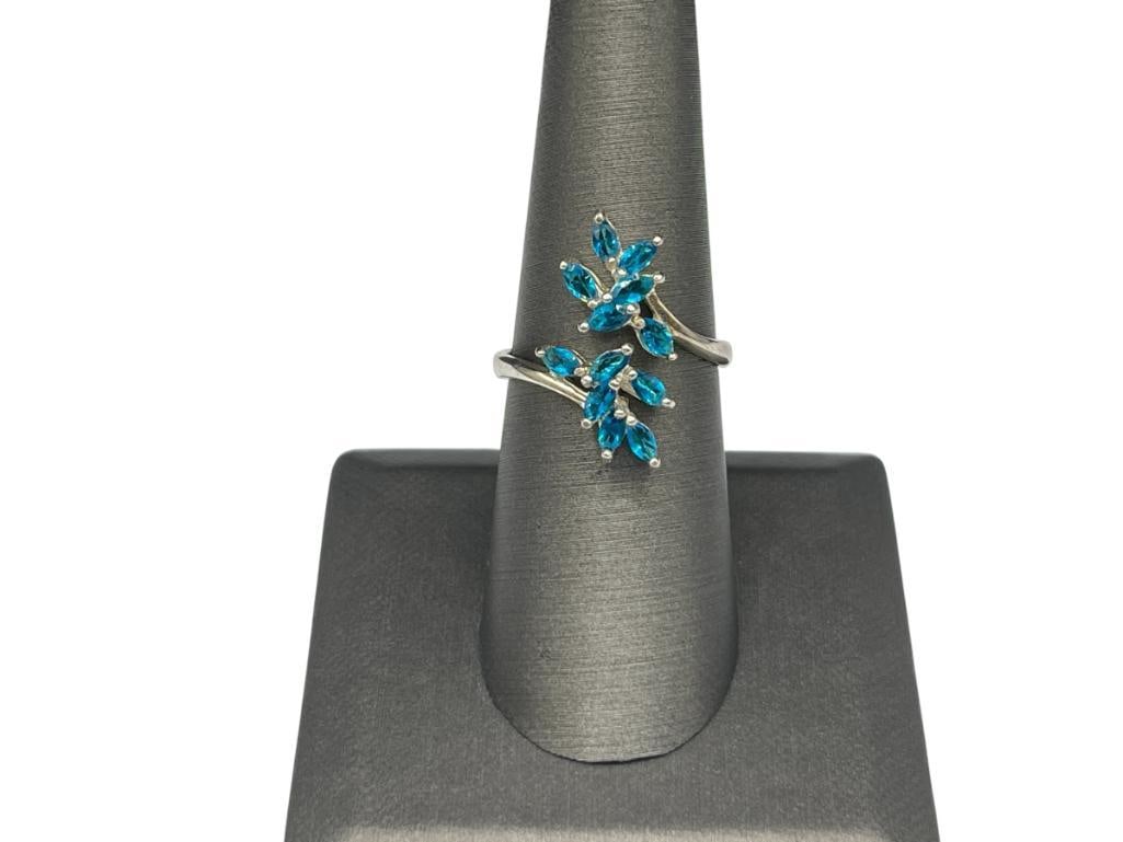 STERLING SILVER SIMULATED BLUE STONE FASHION BYPASS RING FEATURING FLORAL DESIGN: MARQUISE CUT STONES BYPASS DESIGN ALLOWS ADJUSTABLE SIZE, 7/8" FRONT, 3.05 GRAMS 