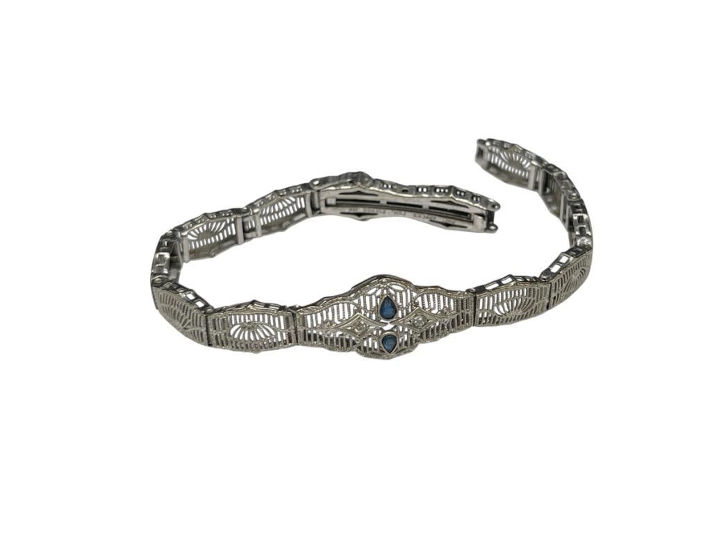 VINTAGE 10K WHITE GOLD ESEMCO DESIGNER SIGNED FILIGREE BAND WITH BLUE SAPPHIRES AND DIAMONDS: BAND'S CLASP NEEDS REPAIR, ACCENTED BY TWO PEAR CUT BLUE SAPPHIRES AND TWO ROUND CUT DIAMONDS 6 3/4", 8.10 GRAMS, 3MM SAPPHIRES, 1MM DIAMONDS 