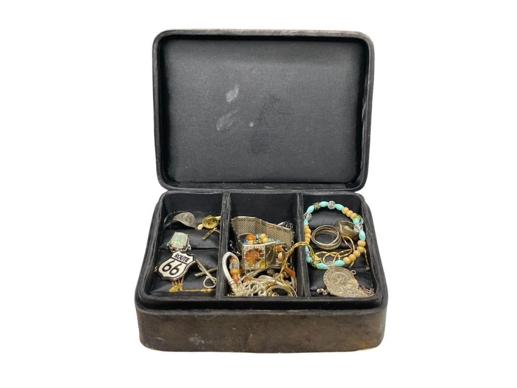 VINTAGE JEWELRY BOX FILLED WITH VARIOUS JEWELRY INCLUDING SOME STERLING SILVER: GOLD TONE PINS, ROUTE 66 PIN, STERLING RINGS AND BRACELET, AND MORE CASE IS 6" X 4" X 2 1/4" 