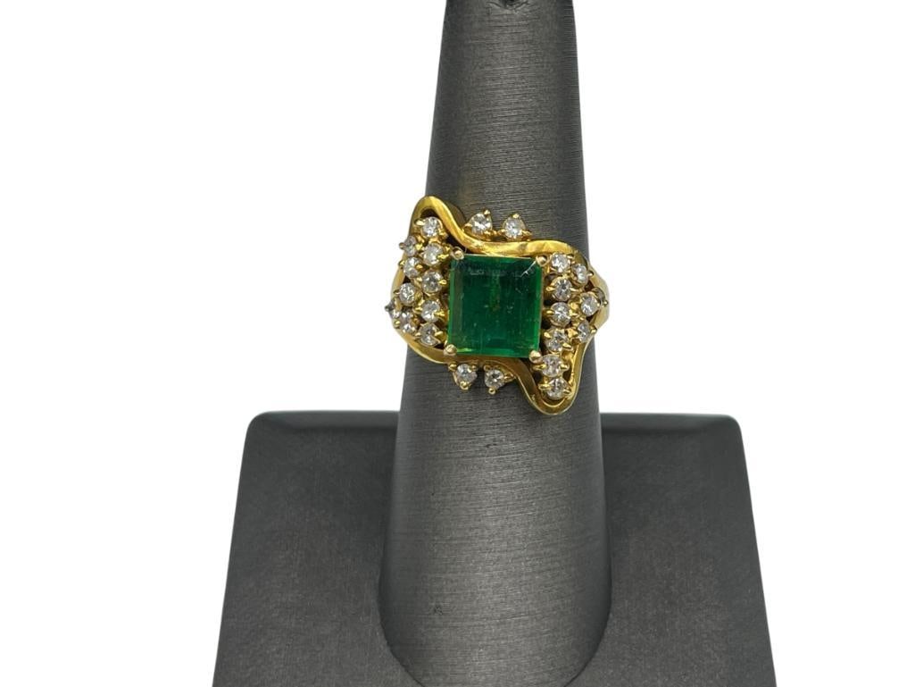 18K YELLOW GOLD PRINCESS CUT EMERALD AND DIAMOND FASHION RING: FEATURING A PRINCESS CUT EMERALD ACCENTED BY 24 ROUND BRILLIANT CUT DIAMONDS SIZE 7, 9MM X 8MM EMERALD, 2MM DIAMONDS, 3/4" FRONT, 10.33 GRAMS 