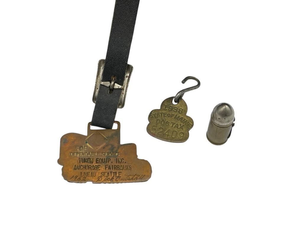 1938 DOGTAX STATE OF MAINE BADGE AND 1962 YUKON EQUIP. ANCHORAGE TRACTOR WATCH FOB: ALSO INCLUDES FIGURAL BULLET SNUFF BOX TRACTOR FOB IS 2" 