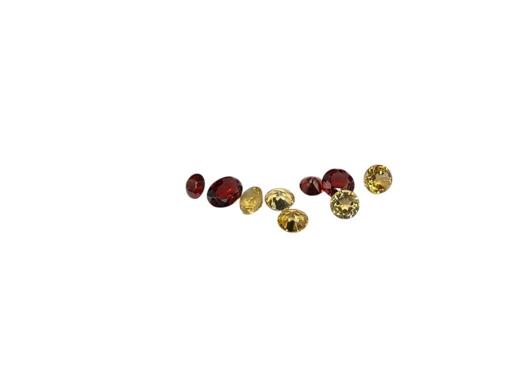 THREE GARNETS AND FIVE RUBIES FEATURING ROUND AND OVAL CUTS: 4.5CTTW 