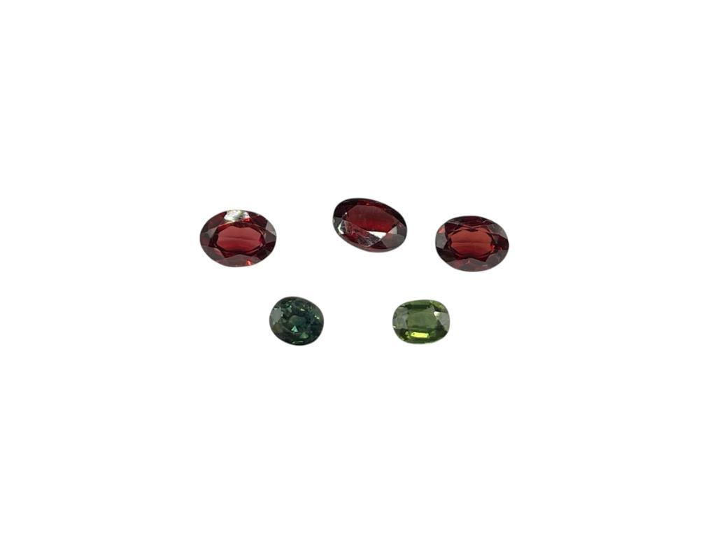 TWO BLUE GREEN SAPPHIRES AND THREE OVAL CUT GARNETS: 5.85CTTW 