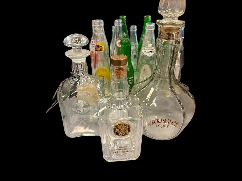 JACK DANIELS WHISKY COLLECTIBLE GLASS BOTTLES: 1915 GOLD MEDAL BOTTLE, 125TH ANNIVERSARY ETCHED BOTTLE, AND OLD NO.7 BOTTLE, EACH WITH ORIGINAL STOPPER 9", 10", AND 13" H 