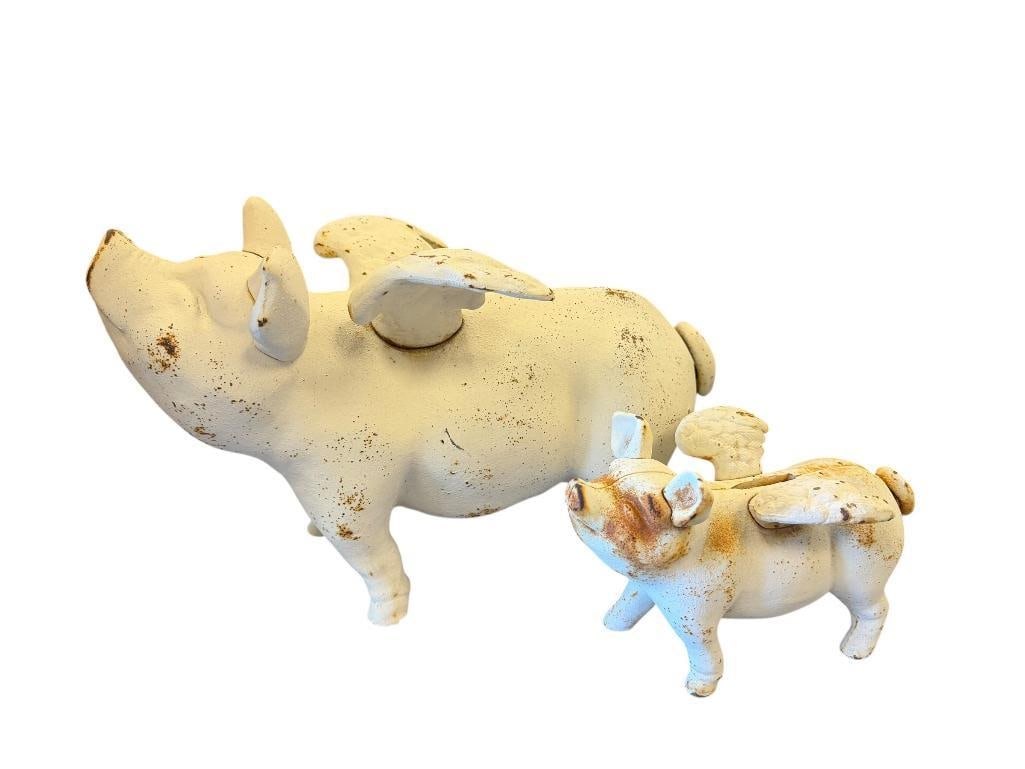 VINTAGE CAST IRON WHEN PIGS FLY CAST IRON STILL COIN BANKS: IN TWO DIFFERENT SIZED, WEATHERED PATINA WITH SURFACE RUST 7" AND 12 1/2" L 