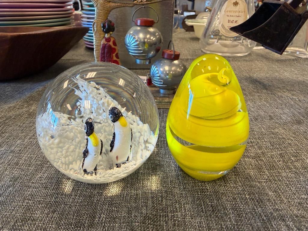 TWO HAND BLOWN ART GLASS PAPERWEIGHTS YELLOW SWIRL EGG PAPERWEIGHT AND PENGUIN PAPERWEIGHT: NO CHIPS BOTH MEASURE 3"