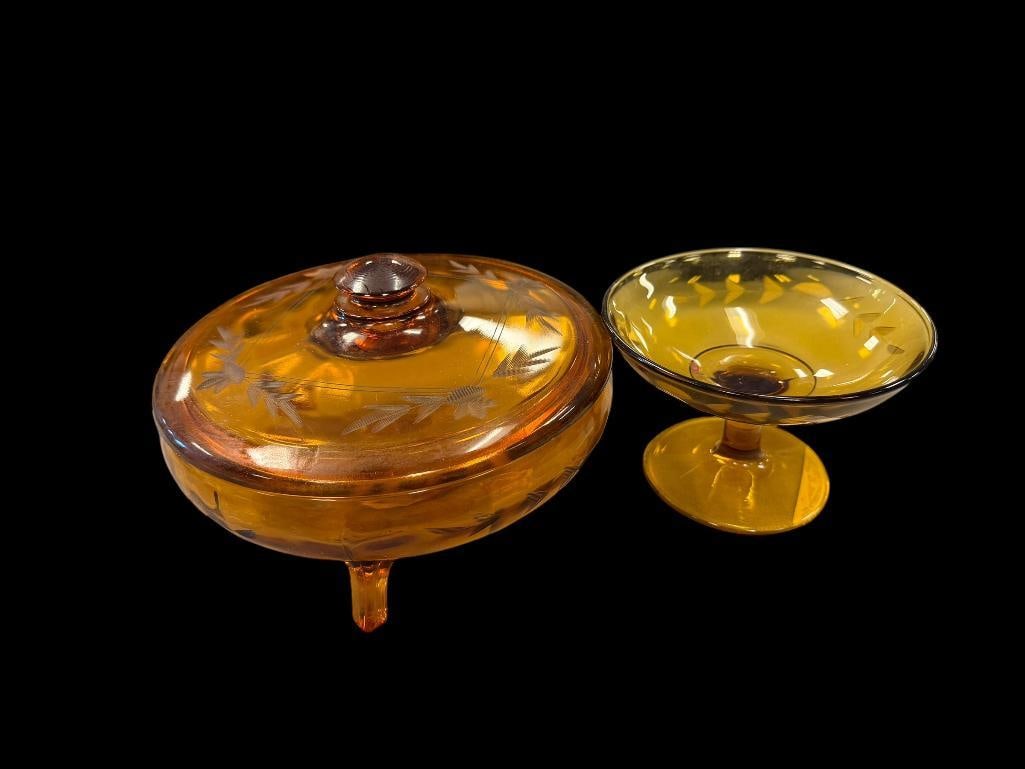 TWO PIECES OF VINTAGE AMBER GLASS INCLUDING FOOTED COMPOTE AND FOOTED COVERED CANDY DISH: EACH WITH ETCHED LEAF PATTERN, NO CHIPS OR CRACKS CANDY DISH IS 7" X 4" 