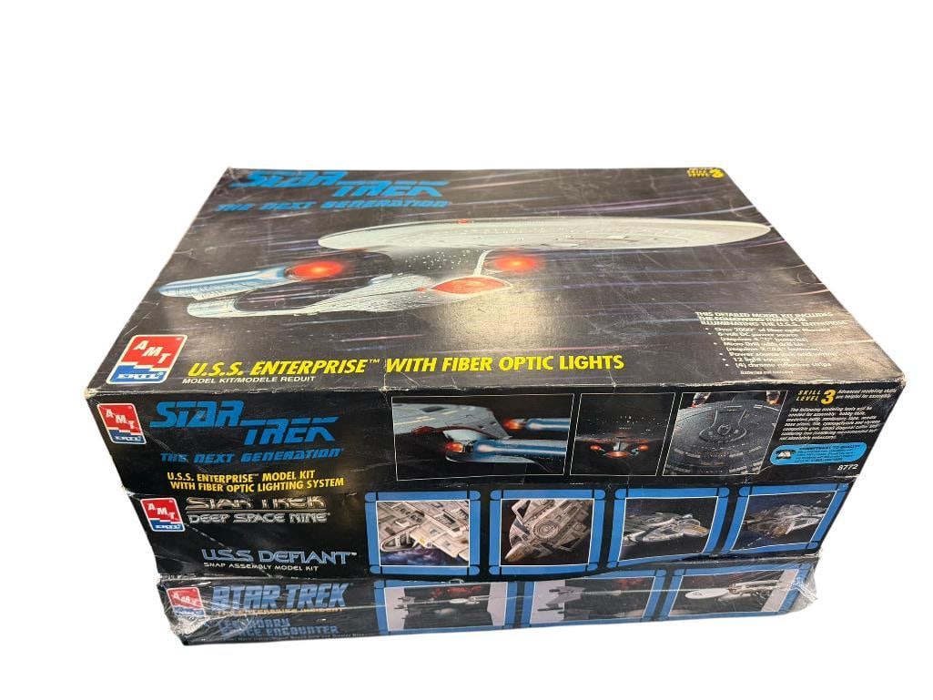 THREE COLLECTIBLE AMT ERTLE STAR TREK MODELS INCLUDING U.S.S. ENTERPRISE WITH FIBER OPTIC LIGHTS: ALSO INCLUDES U.S.S. DEFIANT SNAP ASSEMBLY MODEL KIT AND LEGENDARY SPACE ENCOUNTER WITH FIBER OPTIC LIGHTS, DIGITAL SOUND CHIP, AND DISPLAY BASE, LAST ONE IS STILL SEALED BOXES ARE 17 1/2" X
