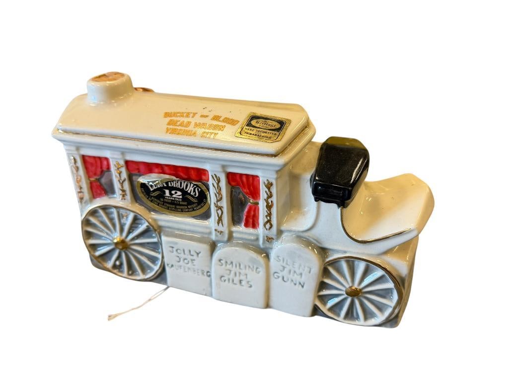1970 HERITAGE CHINA EZRA BROOKS BUCKET OF BLOOD VIRGINIA CITY, DEAD WAGON DECANTER: HISTORIC BUCKET OF BLOOD SALOON DECANTER, MISSING STOPPER, EMPTY 9 1/2" L 