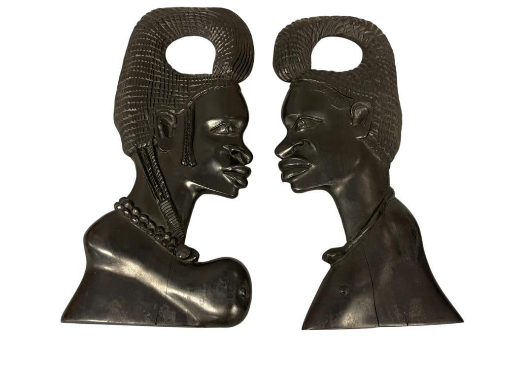 MID-CENTURY HAND CARVED AFRICAN EBONY WOOD SCULPTED MASKS: MALE AND FEMALE MASKS WITH DISTINCTIVE HAIRSTYLES, POSSIBLY FROM WEST AFRICA 17" AND 17 3/4" H 