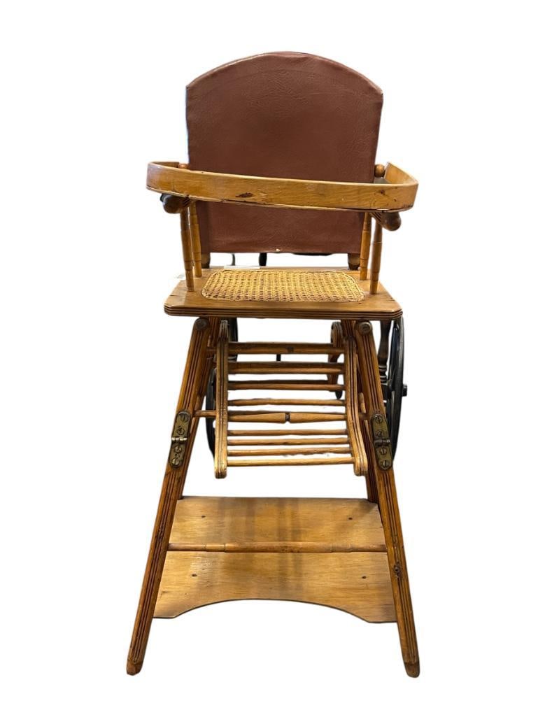 ANTIQUE CONVERTIBLE OAK HIGH CHAIR / STROLLER / AND LOW CHAIR ALL IN ONE DESIGN: FEATURING HAND PAINTED ELEPHANT UNDER TRAY, CANE SEAT, AND BRASS HARDWARE, FAIR CONDITION 18" X 18" X 24" SEAT HEIGHT, 38" SEAT BACK HEIGHT 