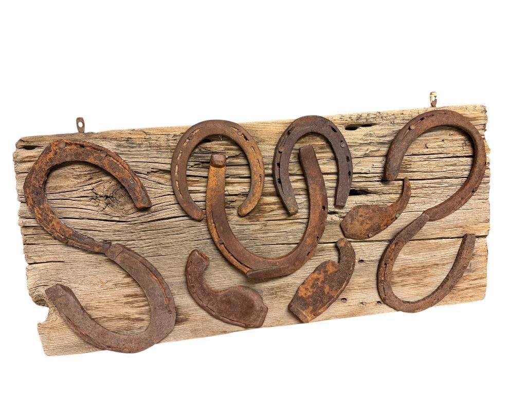 VINTAGE RUSTIC WESTERN MOTIF HORSESHOES ON BARNWOOD WALL ART: FEATURING AUTHENTIC HORSESHOES OF VARIOUS SIZES 24" X 11" 