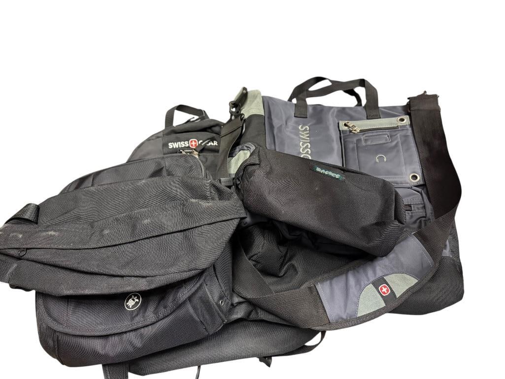 TWO SWISS GEAR BACKPACKS INCLUDING ONE NEW WITH TAGS AND THREE ASSORTED VINYL SMALL TRAVEL BAGS: INCLUDES PACSAFE MULTI-COMPARTMENT SATCHEL BAG LARGEST IS 14" X 16" 
