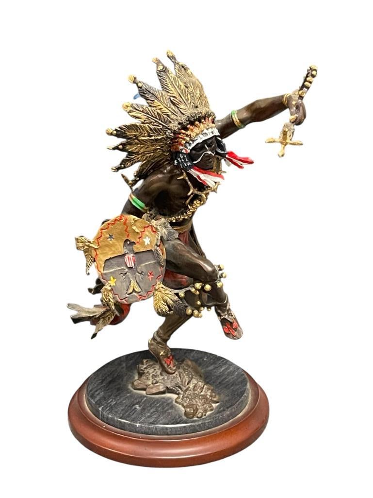 R.F. MURPHY SPIRIT OF THE THUNDERBIRD NATIVE AMERICAN PAINTED BRONZE SCULPTURE FOR THE FRANKLIN M...: DANCING NATIVE AMERICAN BRONZE FIGURE WITH PAINTED ACCENTS, MOUNTED ON ROUND STONE BASE ON TOP OF STEPPED WOODEN ROUND BASE, MARKED ON THE BOTTOM WITH TITLE AND ARTIST NAME 10 1/2" H