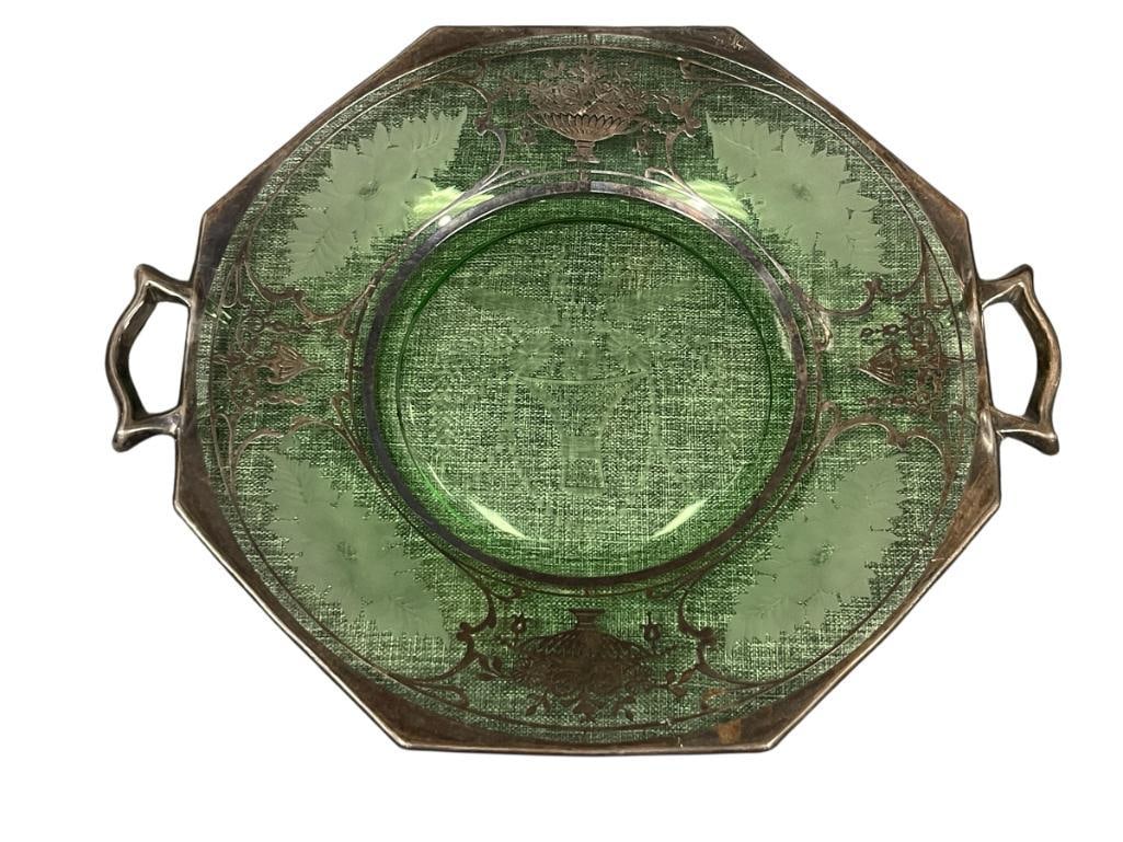 1930'S STERLING SILVER OVERLAY GREEN DEPRESSION GLASS HANDLED TRAY WITH FLORAL ETCHINGS: OCTAGONAL SHAPE DISH WITH HANDLES, FEATURES FLOWERS IN URN OVERLAY DESIGN AND ETCHED FLORAL DESIGN, OVERLAY DOES SHOW SOME LIGHT WEAR, NO CRACKS OR CHIPS 12" HANDLE TO HANDLE