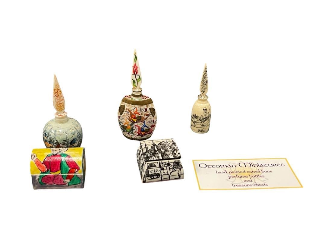 LATE 20TH CENTURY HAND CRAFTED CAMEL BONE TRINKET BOXES AND ISTANBUL / TURKISH PERFUME BOTTLES: EACH PIECE HAS BEEN HAND CARVED FRO CAMEL BONE AND HAVE ALSO BEEN HAND DECORATED WITH CITY SCENES OR TRADITIONAL DESIGNS, THREE PERFUME BOTTLES AND TWO TRINKET BOXES WITH HINGED TOPS 1 1/2" UP TO 4" H