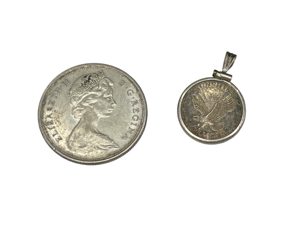 1966 CANADA SILVER HALF DOLLAR AND SUNSHINE MINT SILVER COIN IN BEZEL: 80% SILVER HALF DOLLAR, SUNSHINE COIN IS PER SILVER AND IN STERLING BEZEL PENDANT IS 4.2 GRAMS