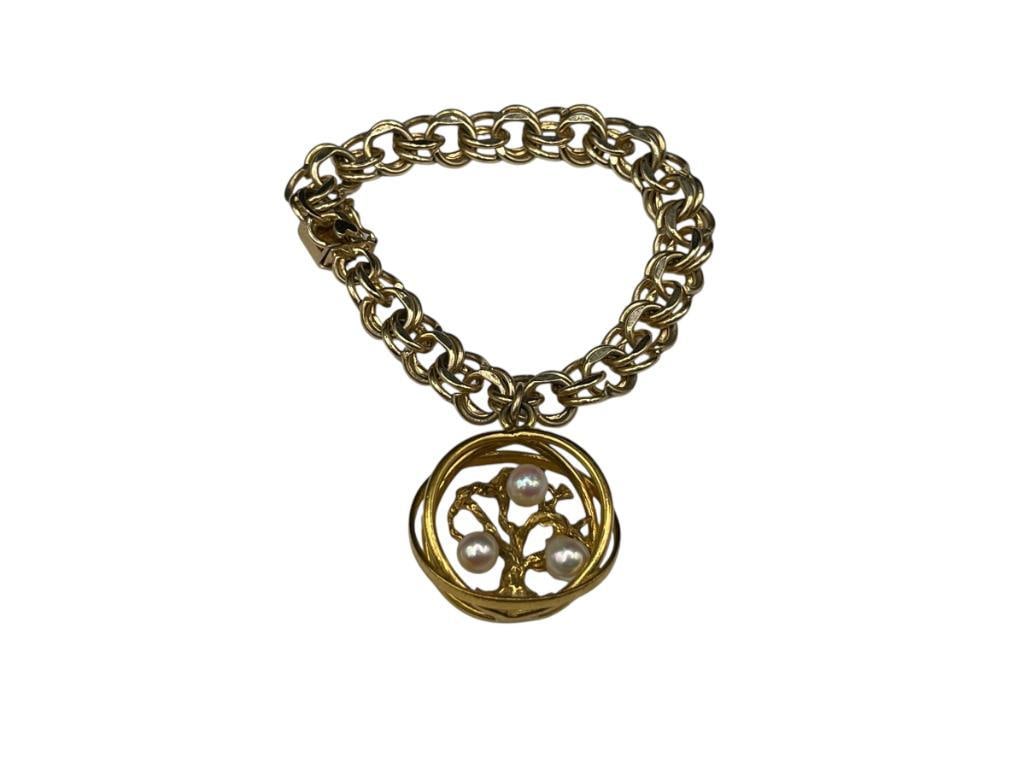 14K YELLOW GOLD LINK BRACELET FEATURING TREE OF LIFE CHARM WITH THREE PEARLS: CLASP IS MARKED BY MAKER 7 1/4" X 3/8" BRACELET, 1 1/4" CHARM, 40.05 GRAMS TOTAL, CHARM IS APPROX. 10 GRAMS 