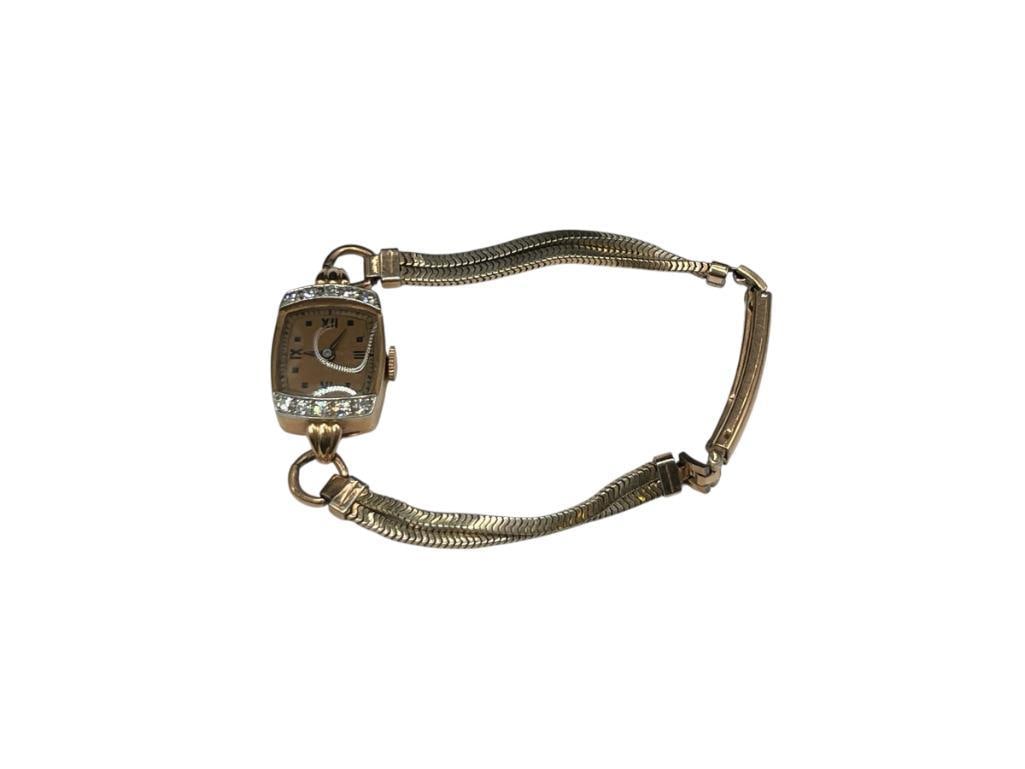 VINTAGE 17 JEWELS LADIES WATCH IN 15K YELLOW GOLD CASE ACCENTED BY 10 ROUND BRILLIANT CUT DIAMONDS: IN RUNNING CONDITION, GOLD FILLED BAND 1.5MM DIAMONDS, CASE WITH WATCH MOVEMENT IS APPROX. 7 GRAMS